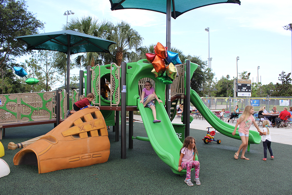 Children playing at the Boundless Dreams playground in Robert P. Miller Park
